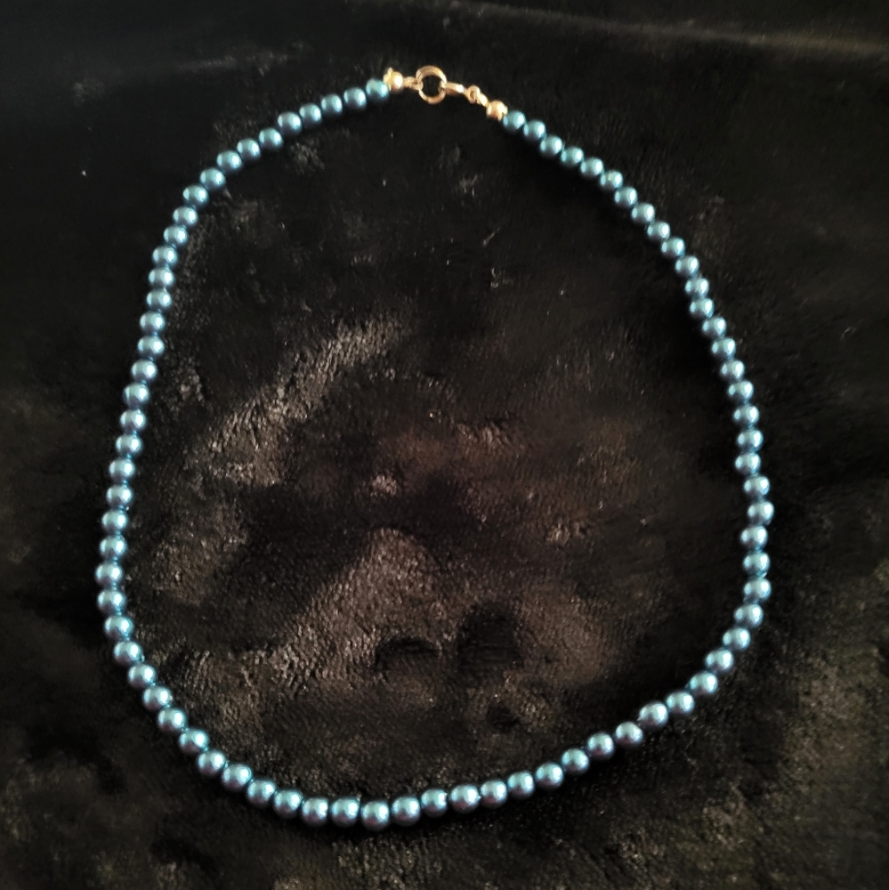 Dark teal beaded necklace.